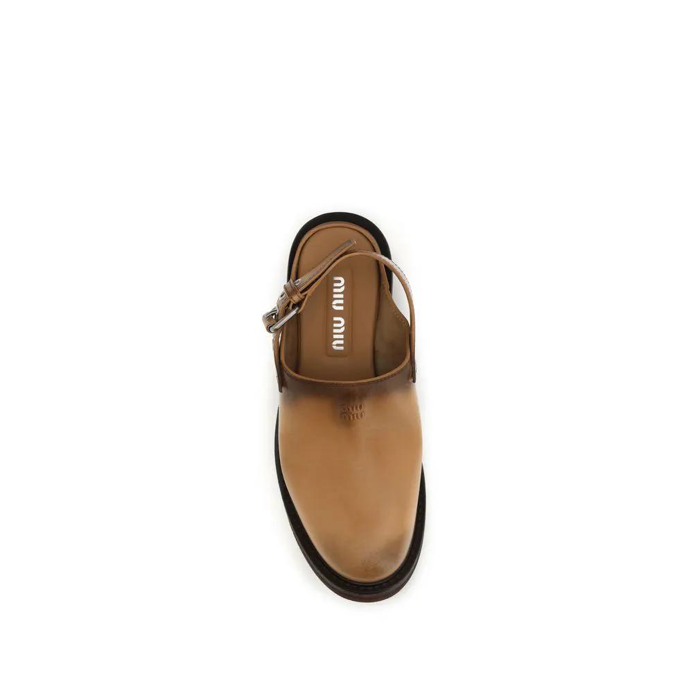 Mules Bos Taurus en cuir de veau marron Miu Miu